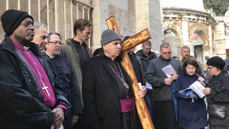 Presiding Bishop Michael Curry participates in walking the Stations of the Cross in 2018 outside the Lutheran Church of the Redeemer in Jerusalem during a Holy Week trip to the Holy Land. Photo: Mary Frances Schjonberg/Episcopal News Service.