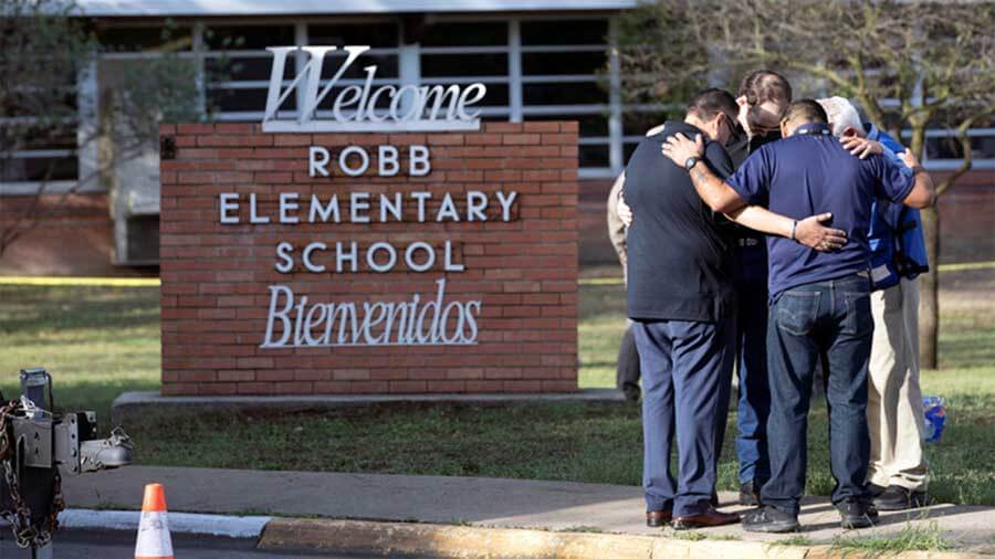 People gather May 25, 2022, at Robb Elementary School, the scene of a mass shooting in Uvalde, Texas. Photo, Reuters