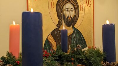 The Advent Wreath with four candles lit in the Education Building in front of the Christ Pantocrator icon