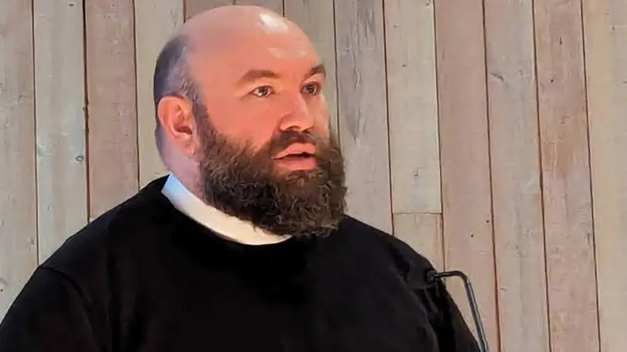 Father Jedediah Fox delivering annual address at the parish meeting in 2024.