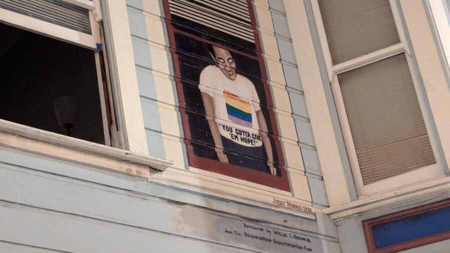A painting of Harvey Milk looking down on Castro Street from his former apartment.