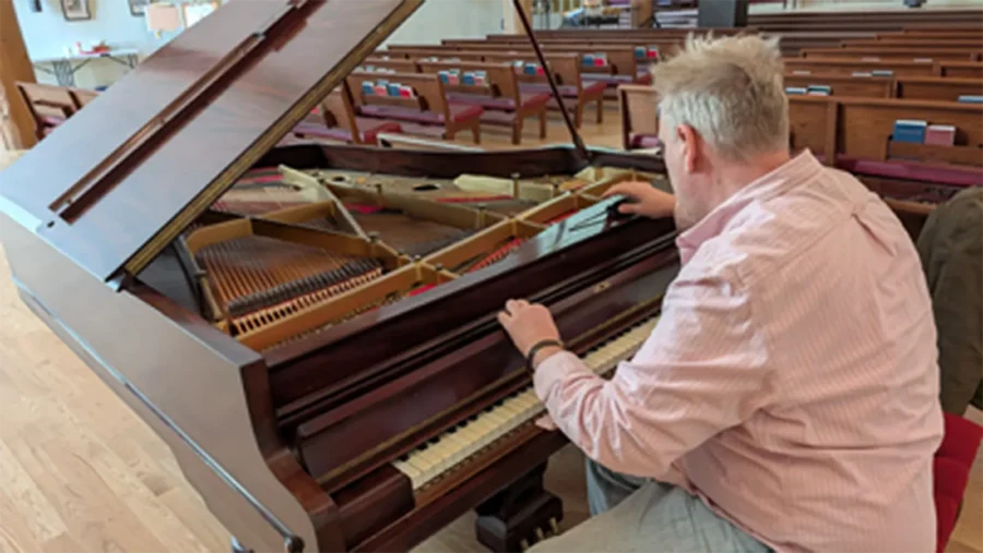 Nathan Jensen working on the piano at Redeemer