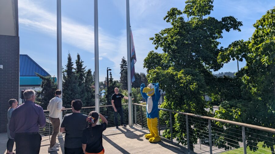 Mayor Nigel Herbig raising Progress Pride Flag on June 1, 2026, at Kenmore City Hall. Hank Heron is cheering Mayor Herbig on.