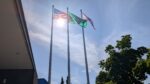 The United States flag, the Washington state flag, and the Progress Pride Flag